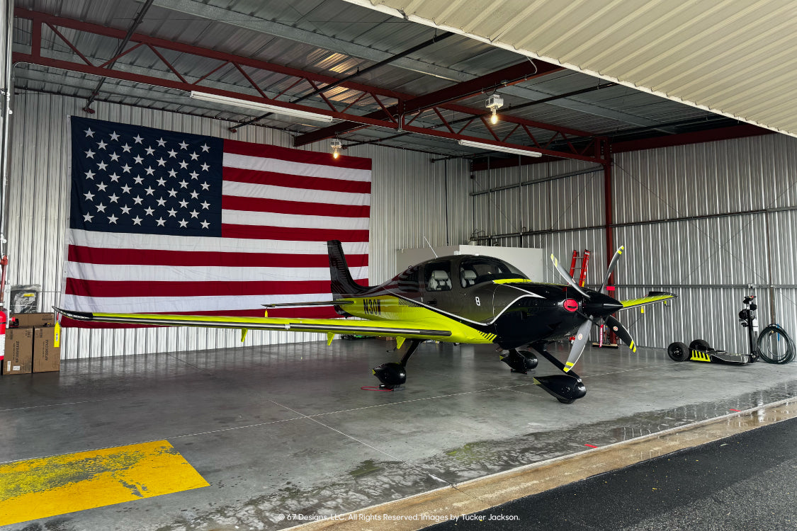 Tucker Jackson's Cirrus SR22 Turbo in Volt in front of American Flag